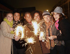 Gruppe junger Menschen, Wunderkerzen am Silvesterabend